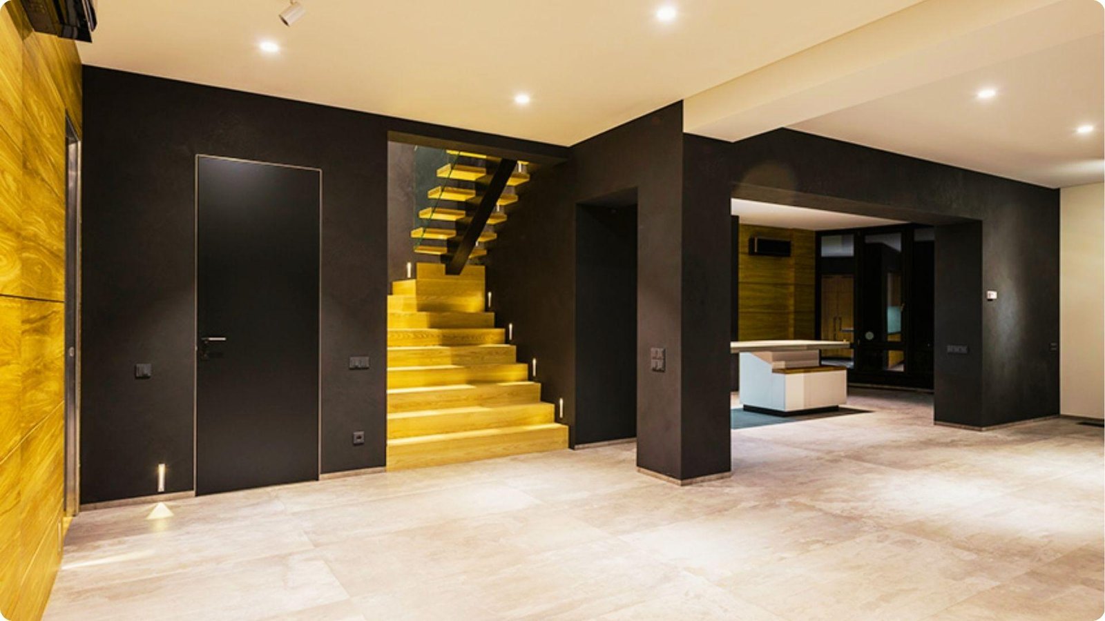 Modern basement remodel with low ceiling concealed by matte black walls and integrated lighting.