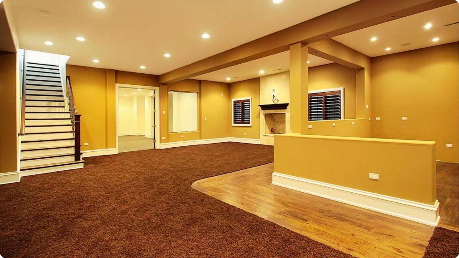 Spacious finished basement with recessed lighting, brown carpet, wood flooring, and a fireplace.