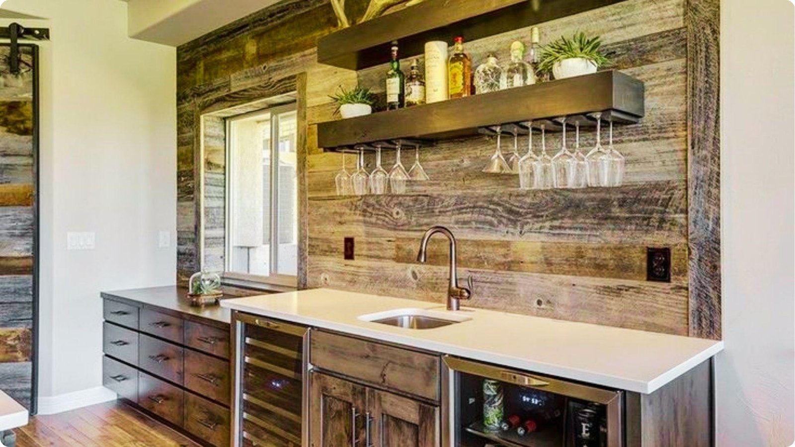 Rustic basement wet bar with reclaimed wood accent wall and floating shelves.