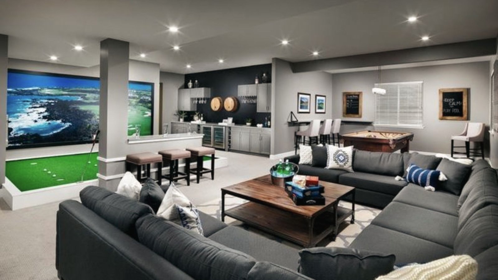 Multi-zone basement with golf simulator, wet bar, pool table and large sectional for entertaining.