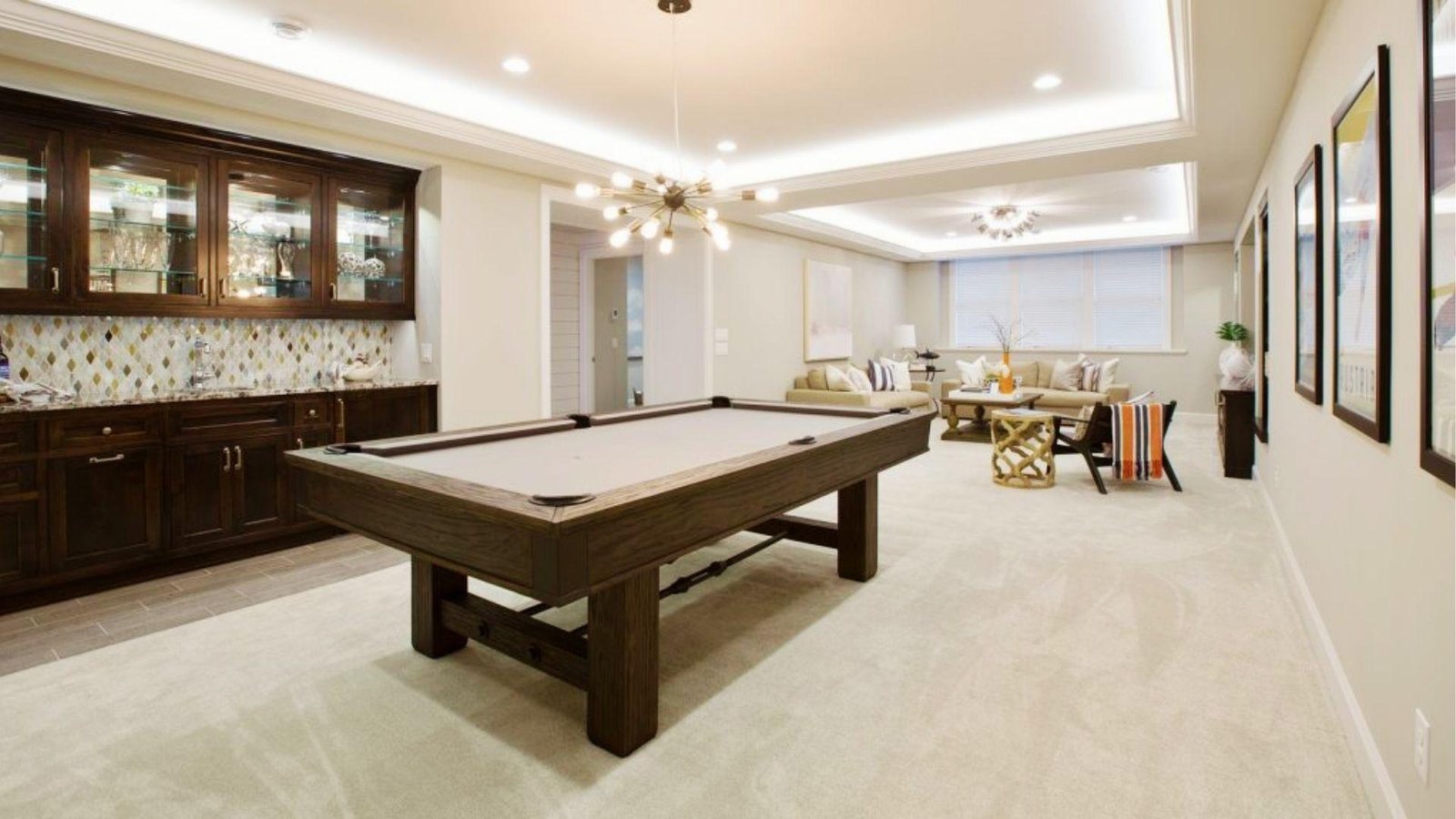 Renovated basement game room with pool table, wet bar, and lounge area increasing total basement renovation cost