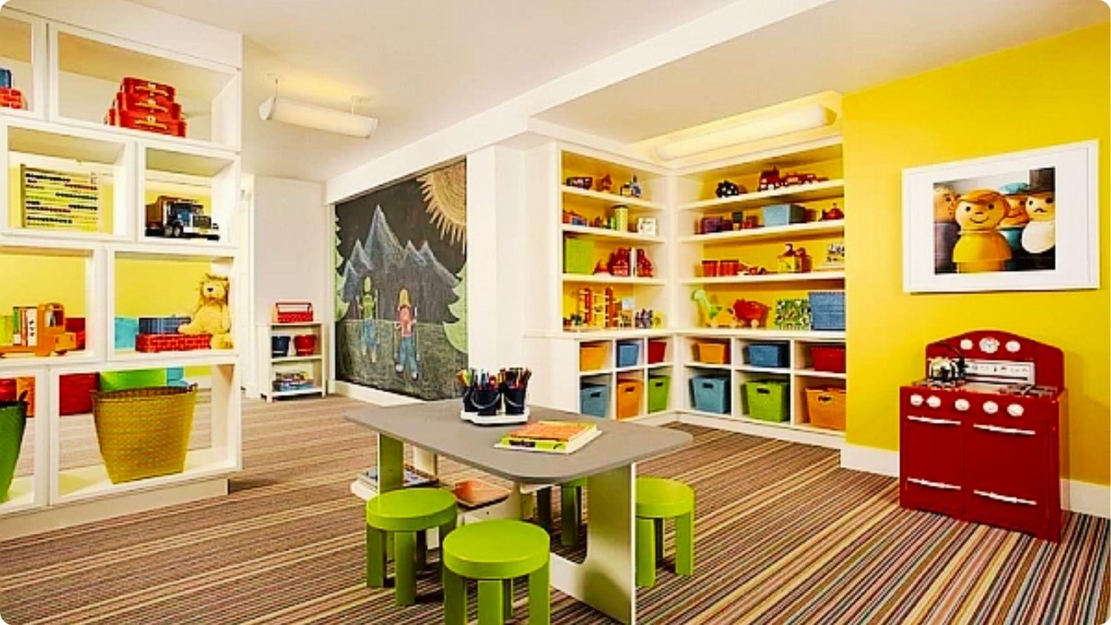 Colorful basement playroom with yellow accent walls, built-in toy shelving, and a central activity table.