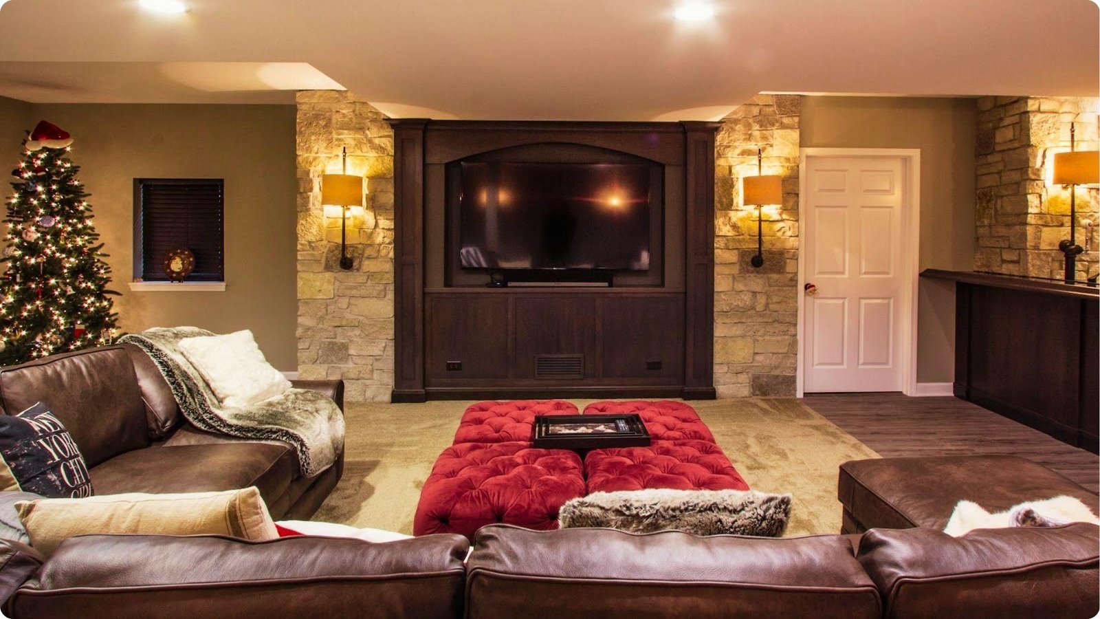 Cozy basement media room with stone walls and warm ambient lighting.