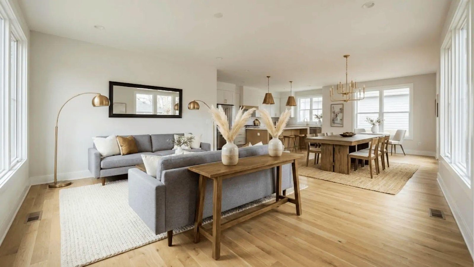 Open-concept finished basement living and dining area with modern decor, showing completed basement renovation cost value.