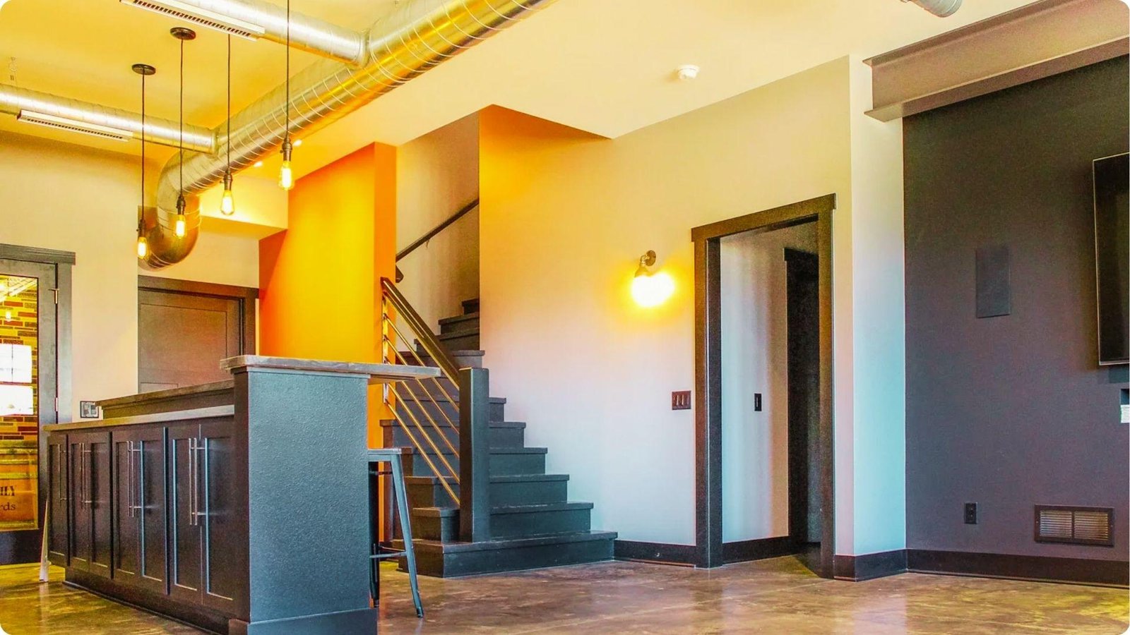 Finished basement with polished concrete floors, exposed ductwork, and drywall partitions.