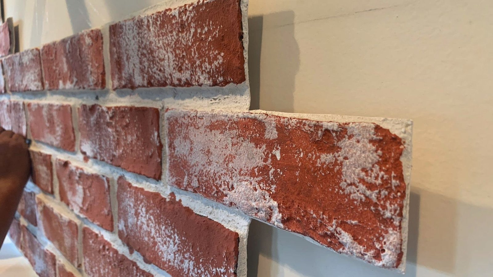 Faux brick accent wall covers sump pump using removable panel for easy maintenance access.